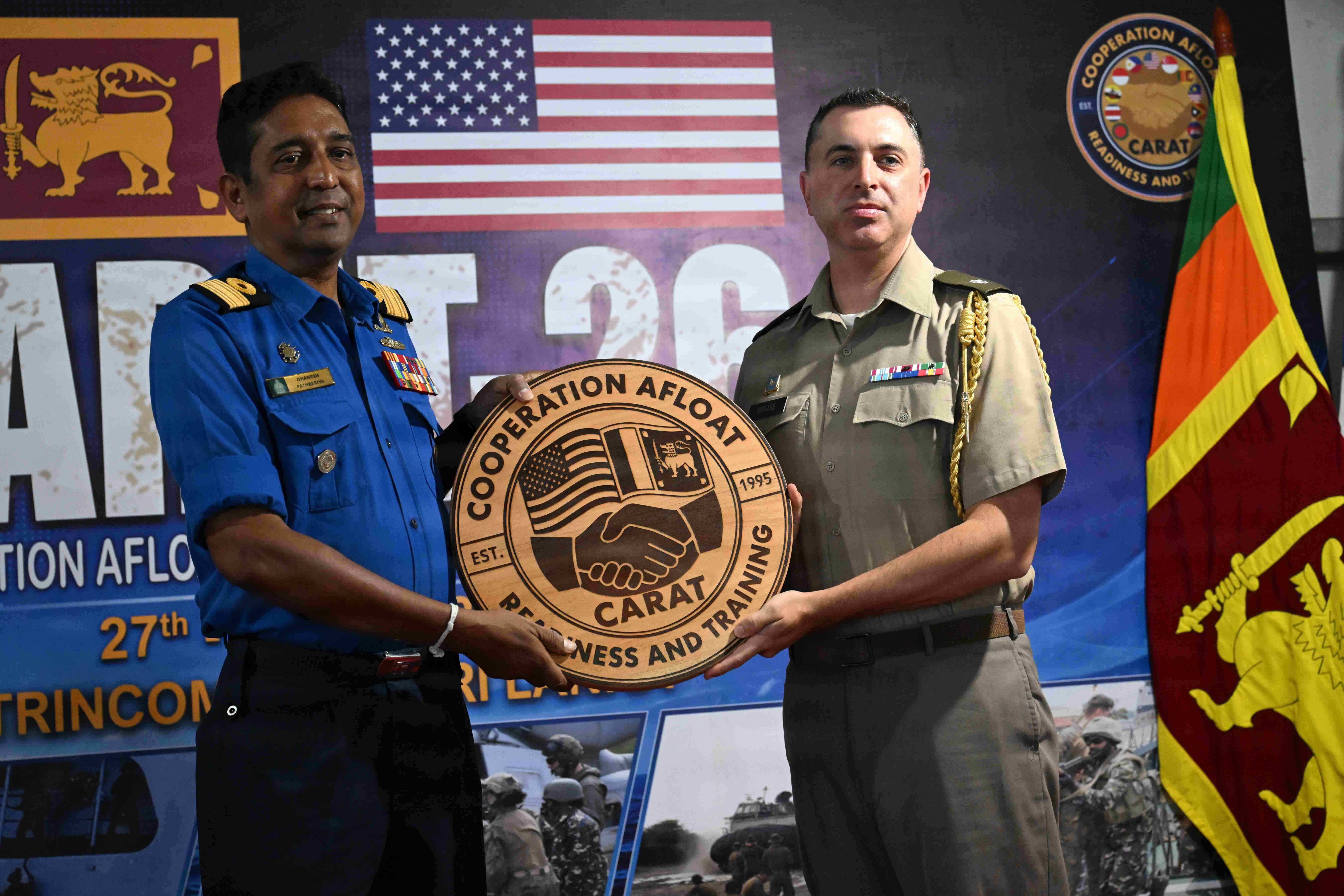 Sri Lanka Navy Commodore Dhanesh Pathberiya, Flag Officer Commanding Naval Fleet, receives an award from U.S. Army Lt. Col. Matthew House, senior defense official and defense attaché to Sri Lanka